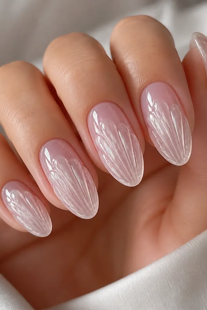 Medium oval nails with a clear pink gel base that looks like ice. Over the center of each nail are icy white shell ridges sculpted in 3D, with smooth rounded peaks. The ridges are semi-translucent and catch light like frost. The nails are glossy, with no extra glitter.