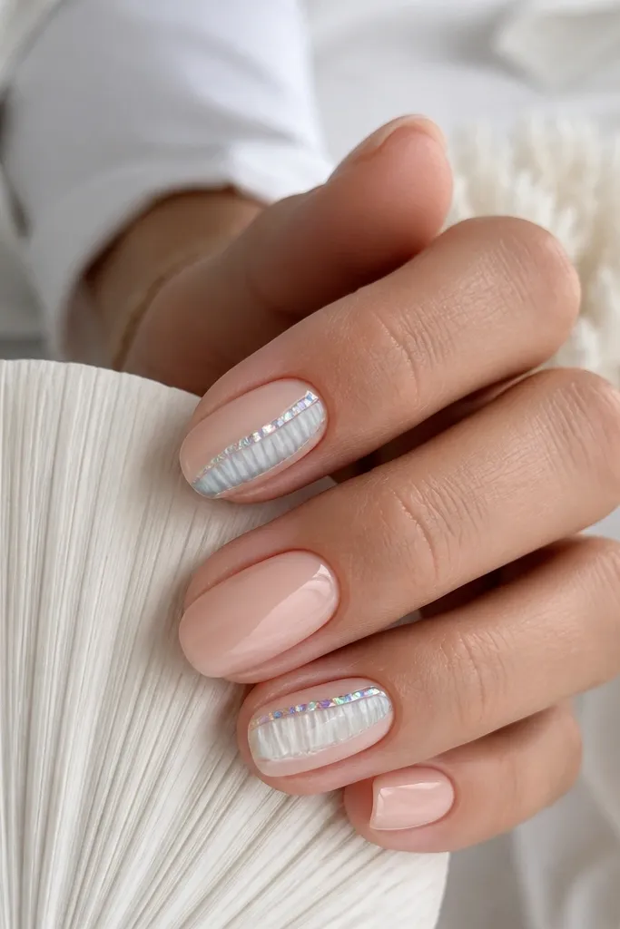 Nude nails with one vertical ridged shell stripe down the center on accent nails. The stripe is white with gray-blue ridges, and a thin strip of iridescent foil runs along one side. Glossy top coat.