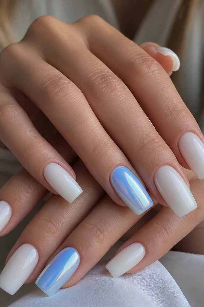 Long square nails in a glossy milky white base. Two accent nails have a mirror-like pool blue chrome sheen with a soft halo effect, while the rest stay solid milky white.