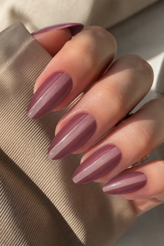 Almond nails in smoky mauve with a clear jelly center stripe running vertically. The center is translucent, showing the base beneath. Glossy shine.