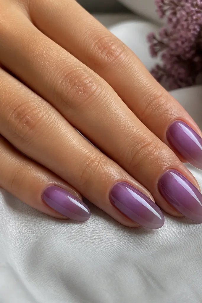 Almond nails with grape sorbet jelly base. A soft lavender aura glow surrounds the center near the cuticle, fading outward. Glossy finish.