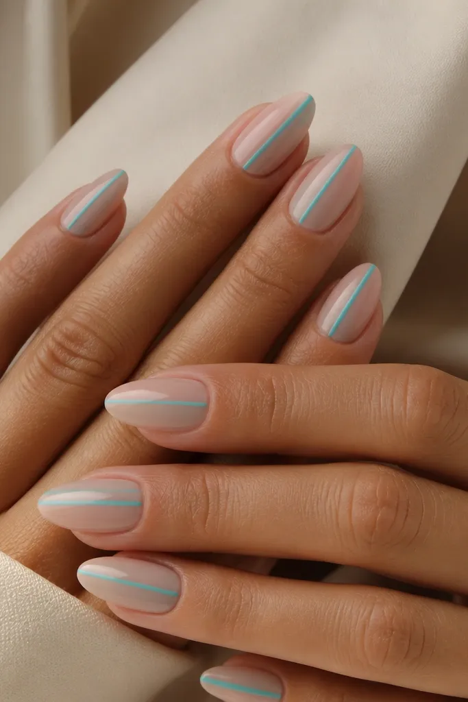 Almond nails with a sheer nude base and one thin turquoise stripe running down one side of each nail, glossy finish.
