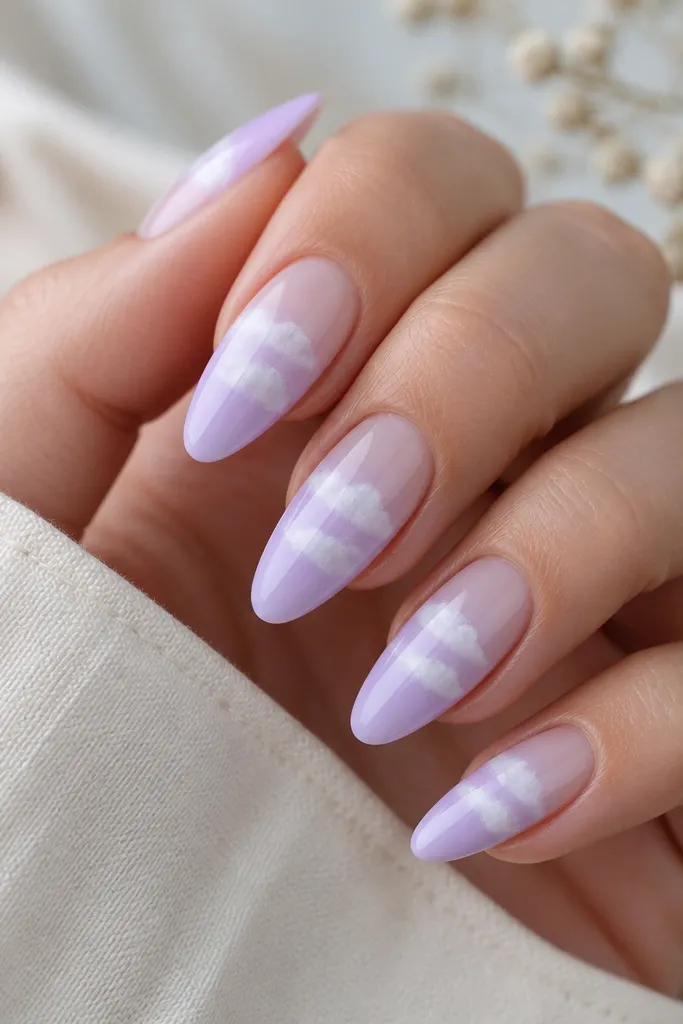 Almond nails with soft lavender gradient from cuticle to tip, plus white cloud-like puffs in the center; glossy finish.