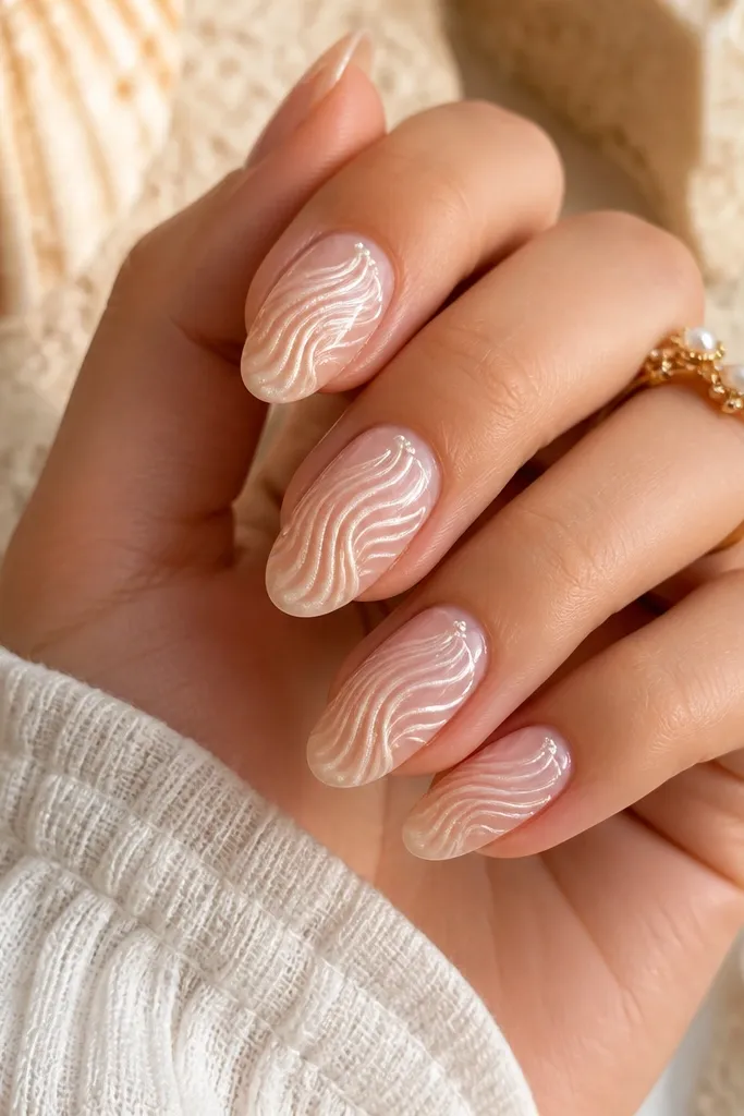 Short oval nails with sheer nude jelly base and ivory shell swirl lines that curve like conch ridges, glossy top coat.