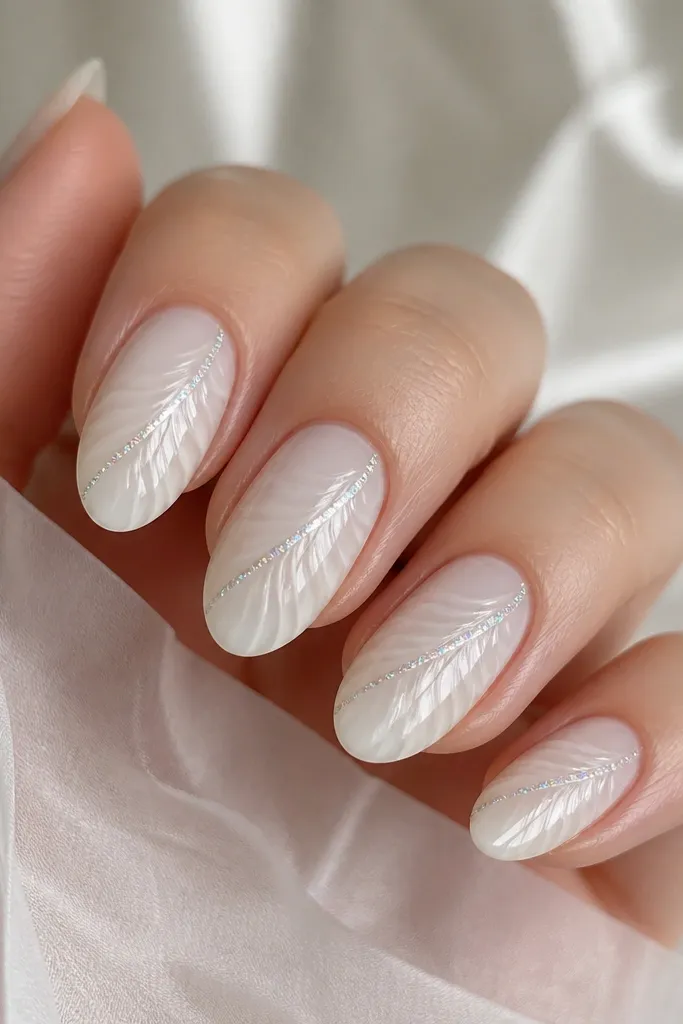 Medium almond nails with a milky white base. Shell ridges are painted in soft white. A thin silver holographic line runs diagonally across each nail like a vein, passing through the ridges. The top coat is extra glossy, reflecting light.